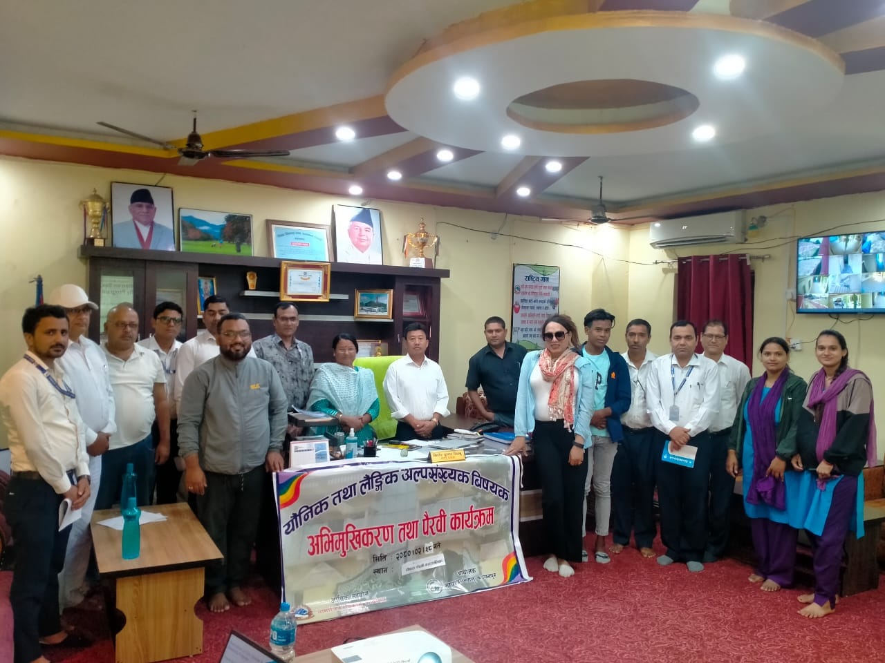 Orientation session in progress with government officials focused on sexual orientation and gender identity education.